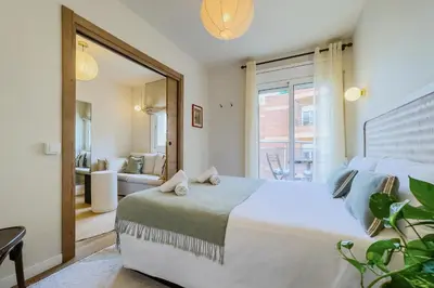 a bedroom with a bed and a large window at Apartamento exclusivo en Sant Antoni in Barcelona