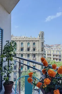a view of a building from a balcony with flowers at Apartamento exclusivo en Sant Antoni in Barcelona