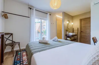 a bedroom with a large bed and a window at Apartamento exclusivo en Sant Antoni in Barcelona