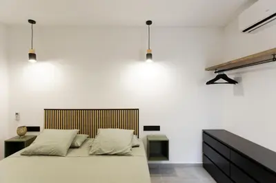 a bedroom with a large bed and white walls at Mediterranean Bliss in Sant Adria de Besos