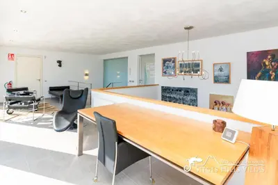 a dining room with a table and chairs at Villa Lucere with private pool near Sitges in Olivella