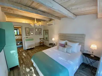 a bedroom with a large white bed in a room at Bed & Breakfast Wine & Cooking Penedès in Pla del Panadés