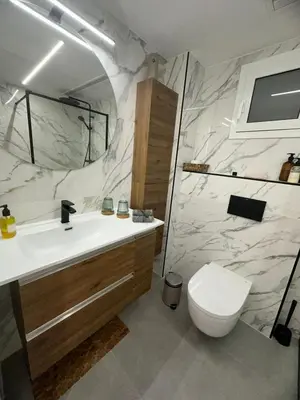 a bathroom with a white sink and a toilet at Vidanova 1 in Vilanova i la Geltrú