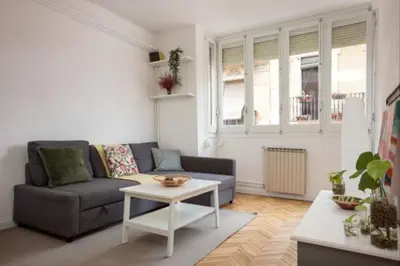 a living room with a couch and a table at Renovated Apartment in Vila de Gràcia in Barcelona