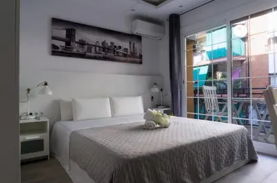 a bedroom with a bed with a teddy bear on it at Warm Harbor in Santa Coloma de Gramanet