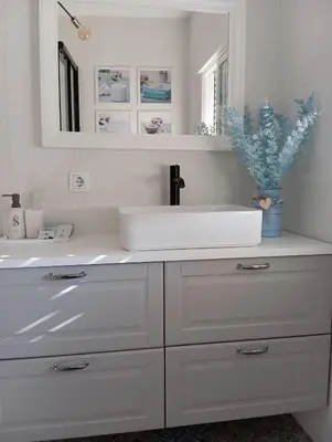 a white bathroom with a sink and a mirror at Warm Harbor in Santa Coloma de Gramanet