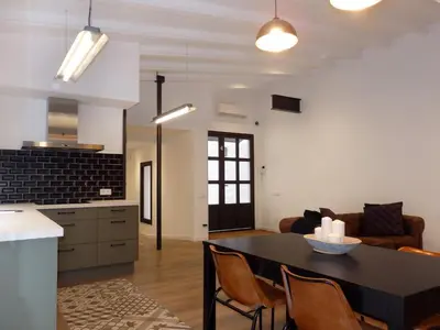 a bedroom with a large bed with blue cabinets at Loft reformado in Cornellà de Llobregat