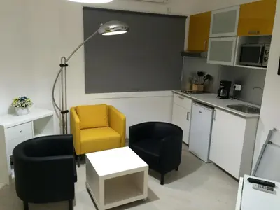 a kitchen with two chairs and a table and a lamp at Marbel 2 in Barcelona
