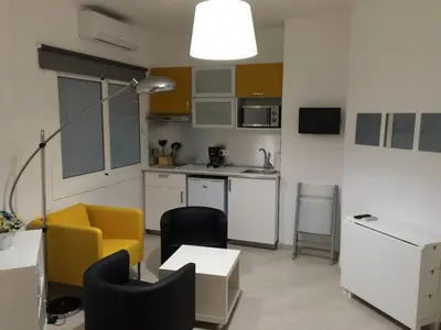 a kitchen with a table and chairs in a room at Marbel 2 in Barcelona
