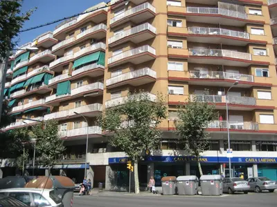 a tall building with cars parked in front of it at Marbel 2 in Barcelona