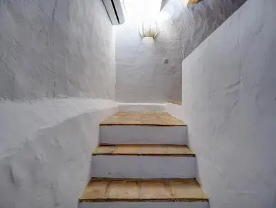 a staircase in a white room with a stair case at Masia Palou Alt by Hello Homes Sitges in Sitges