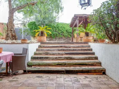 a set of stairs with a table and chairs at Masia Palou Alt by Hello Homes Sitges in Sitges