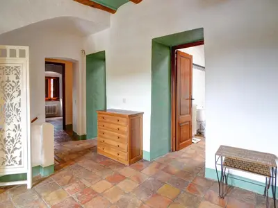 a room with a wooden dresser and green walls at Masia Palou Alt by Hello Homes Sitges in Sitges