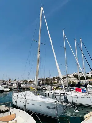 a group of boats are docked in a harbor at Velero Draco in Sitges