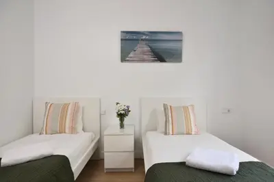 a bedroom with two beds and a pier at Encantador piso en el centro in Barcelona