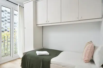 a white room with a bed and a window at Encantador piso en el centro in Barcelona