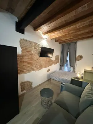 a living room with a couch and a bed at Stay Happy in Barcelona