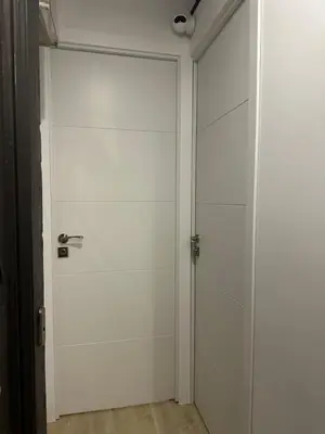a white garage door with a silver door handle at Stay Happy in Barcelona