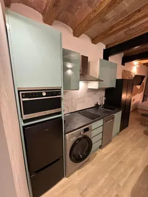 a kitchen with a washing machine and a washer at Stay Happy in Barcelona