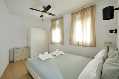 a bedroom with a bed and a ceiling fan at 17 Nice apartment next to El Molino in Barcelona