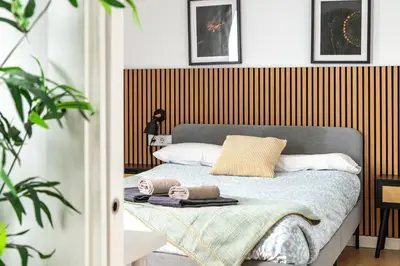 a bedroom with a bed with two towels on it at StayCampNou 1BR with Balcony in Hospitalet de Llobregat