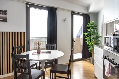 a kitchen and dining room with a table and chairs at StayCampNou 1BR with Balcony in Hospitalet de Llobregat