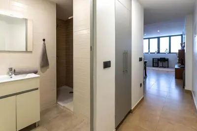 a bathroom with a sink and a toilet in a room at Acogedor apartamento Diagonal Mar in Barcelona
