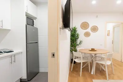 a kitchen and dining room with a table and chairs at Lindo apartamento Montjuïc in Barcelona