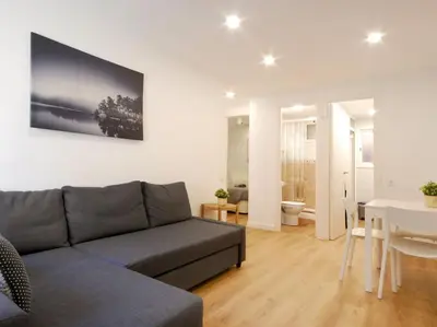 a living room with a couch and a table at Lovely and cozy apartments near Barcelona in Hospitalet de Llobregat