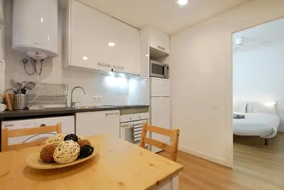 a kitchen with a table with a plate of food on it at Lovely and cozy apartments near Barcelona in Hospitalet de Llobregat