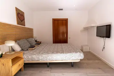 a bedroom with a bed and a flat screen tv at Magnífico apartamento en el centro in Barcelona