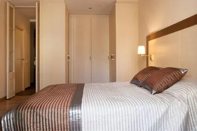 a bedroom with a large bed with a pillow on it at EL born - spacious 2 bedrooms in Barcelona