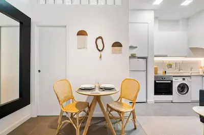a kitchen with a table and chairs in a room at Lodging Apartments Almirall Beach B2 in Barcelona