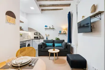 a living room with a couch and a table at Lodging Apartments Almirall Beach B2 in Barcelona