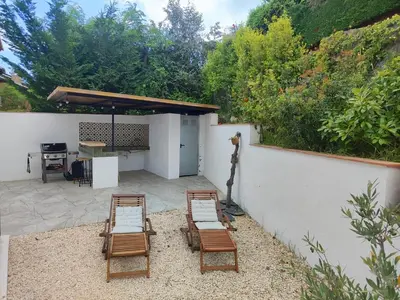 a patio with four chairs and a table and a table at Apartment in Premia de Dalt
