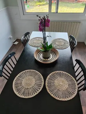 a white vase with flowers in it on a table at Apartment in Premia de Dalt