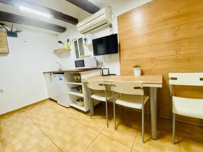 a small kitchen with a table and chairs at 45 Center Basic 1 2 in Barcelona