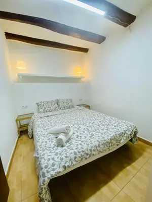a bedroom with a bed with a white comforter at 45 Center Basic 1 2 in Barcelona