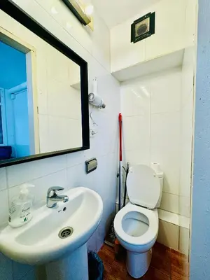 a bathroom with a white toilet and a sink at 044 Velvet 1 3 in Barcelona