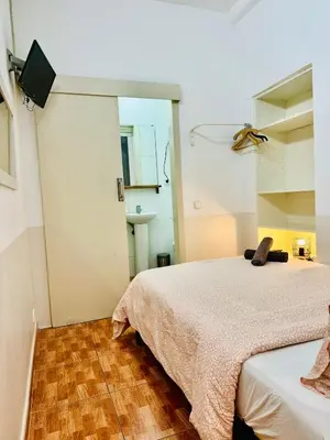 a bedroom with two beds and a television in it at 044 Velvet 1 3 in Barcelona