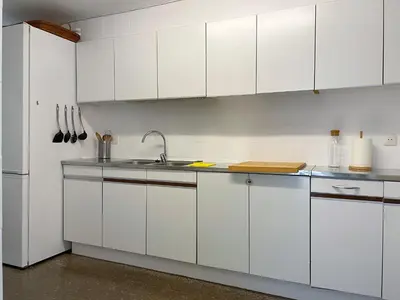a kitchen with white cabinets and a sink at Apartment Vicente in Vilanova i la Geltrú