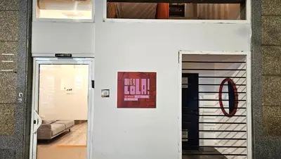 a white wall with a door to a room at HeyLola! Hostel in Barcelona