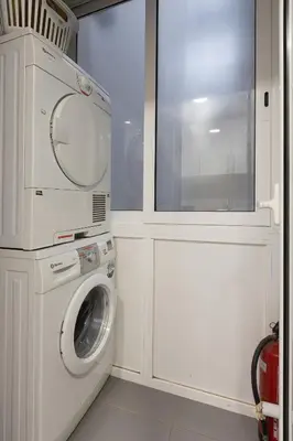 a laundry room with a washing machine and a window at Lets Holidays Centric Apartment in Barcelona in Barcelona