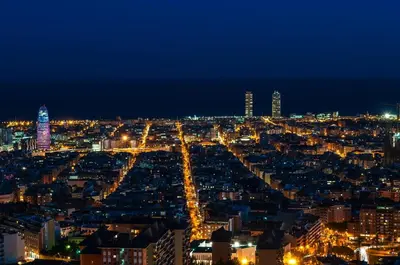 a city lit up at night with lights at Lets Holidays Centric Apartment in Barcelona in Barcelona