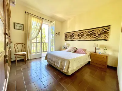 a bedroom with a bed and a large window at Casa Annie in Collbató