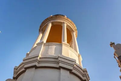 a clock tower with a blue sky in the background at The Diagonal Suites Atic by Sweett in Barcelona