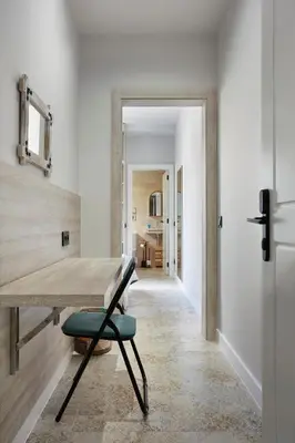 a dining room with a wooden table and a chair at Urban Sabadell 2 in Sabadell