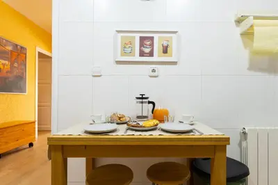 a kitchen with a table with plates of food on it at Vincent's House in Barcelona