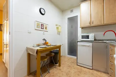 a small kitchen with a table and a microwave at Vincent's House in Barcelona