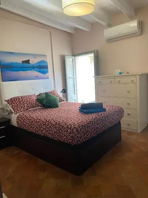 a bedroom with a bed and a painting on the wall at Piso Rustico Calle de la Font Vilafranca del penedes in Vilafranca del Penedès